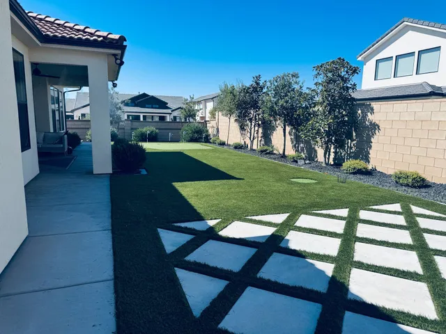 Wide view of a freshly cleaned artificial turf backyard in St. George