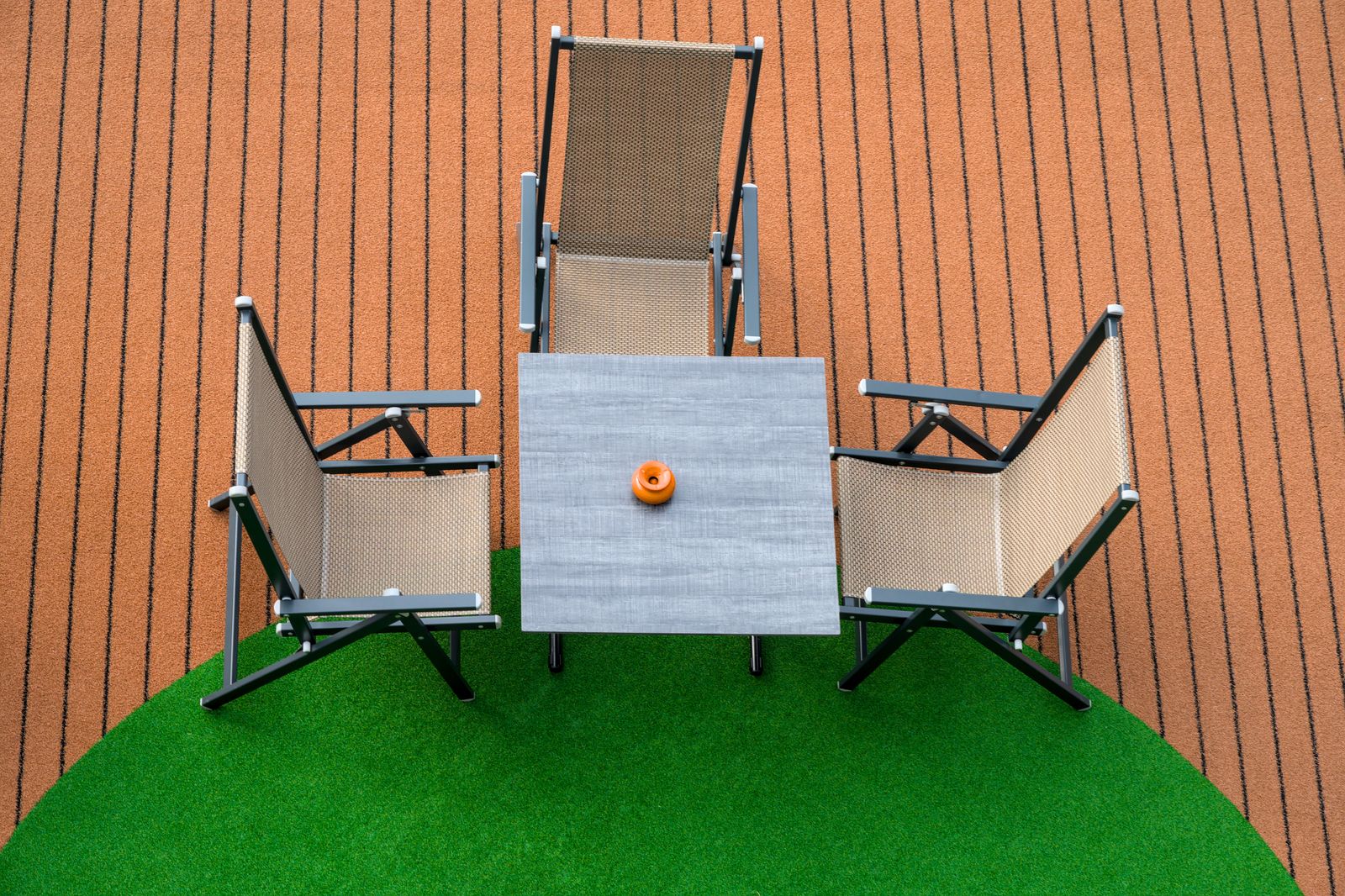 Patio furniture on green artificial turf, seen from above